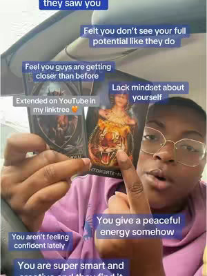 A woman holds two tarot cards up close, framed from the chest up. She is wearing eyeglasses and a pink sweatshirt. Various text boxes are overlaid on the image with statements about a tarot reading.