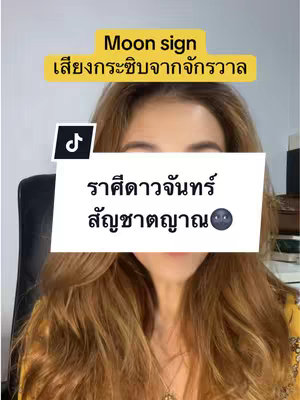 A woman with long brown hair is centered in the frame, looking at the camera. Text overlays appear at the top in a yellow rectangle and at the center in a white rectangle. The background is a blurred neutral tone.