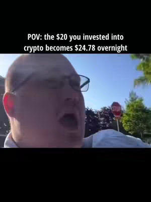 A man with glasses and fair skin is seen reacting with an open mouth and wide eyes to something off-camera. The background includes a street scene with a stop sign and greenery, filmed in daylight. Text overlay reads, 'POV: the $20 you invested into crypto becomes $24.78 overnight.'