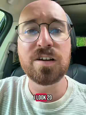 A man with glasses is filming from inside a car. A red rectangular text overlay at the bottom reads "I LOOK 2D."