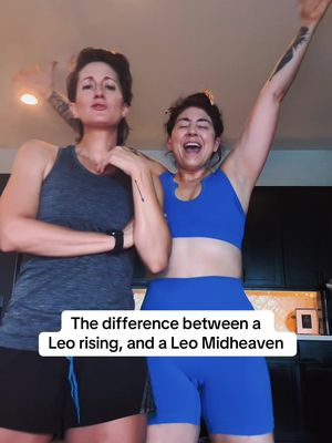 Two women in athletic attire are posing indoors. The one on the left is wearing a gray tank top and black shorts with her arms crossed, while the other is wearing a blue sports bra and shorts. Text overlay on the bottom that says 'The difference between a Leo rising, and a Leo Midheaven'.