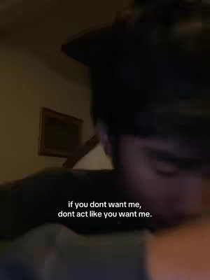 The cover image features a dimly lit room. A person's face is partially visible in the foreground, out of focus. Text overlayed over the image reads, "if you dont want me, dont act like you want me."