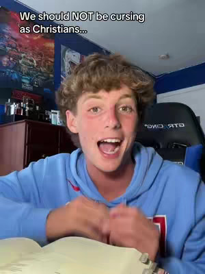 A young man with curly brown hair and a blue hoodie is the focus, looking directly at the camera with an open mouth, as if speaking excitedly. Text overlays read 'We should NOT be cursing as Christians...' with a room backdrop including artwork and furniture.