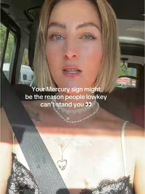A woman is sitting in the car with the text overlay on top of the image.