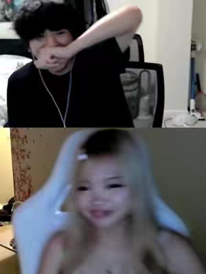 The cover image shows a split screen. The top half features a male figure with black hair, wearing a black shirt, and covering his mouth with his hand, as if reacting or stifling a laugh. The bottom half displays a female figure with blonde hair, appearing to be in a brightly lit room.