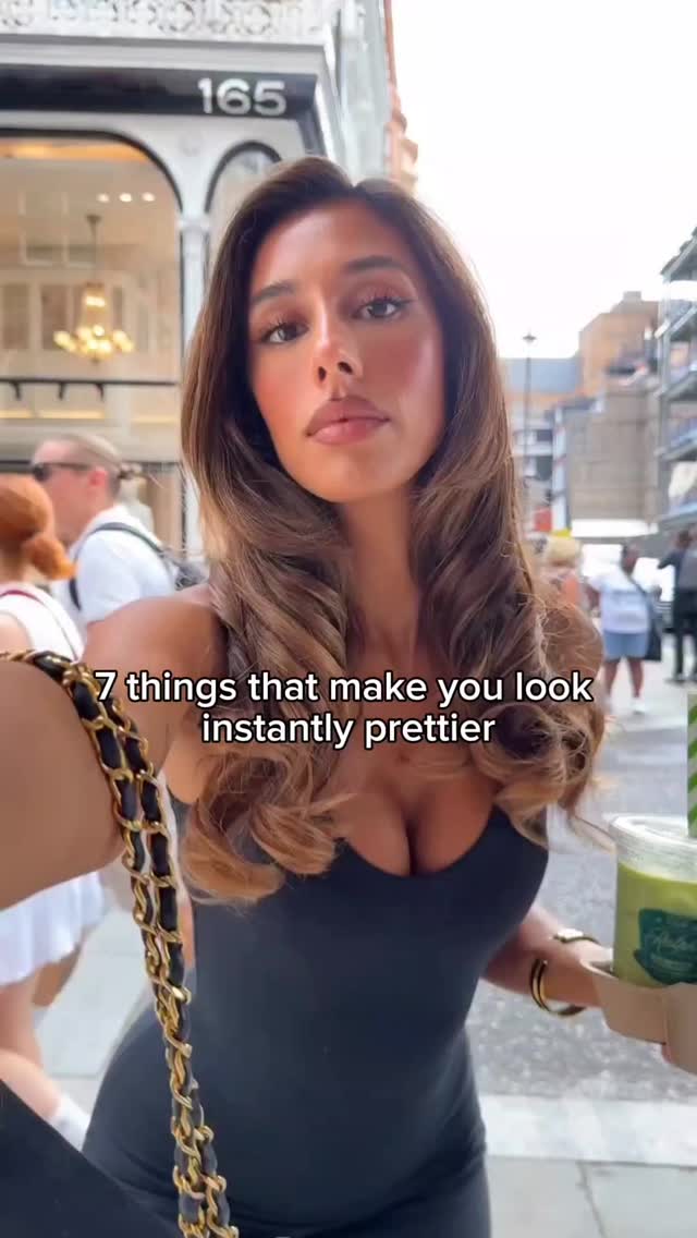 The cover image features a woman in an outdoor setting. She is holding a drink and a black and gold chain bag. The text overlay reads: "7 things that make you look instantly prettier."