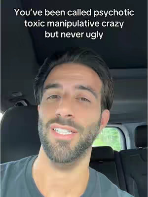 A selfie-style image featuring a man in a car, the focus being on his face. He has a beard. Above him, the text overlay reads, 'You've been called psychotic toxic manipulative crazy but never ugly'.