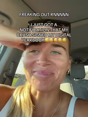 A woman with blonde hair is smiling and looking directly at the camera inside a car. Text overlays, including the phrase "FREAKING OUT RNNNNN" and a caption about a digital yearbook and her crush, are present. The color palette is dominated by natural tones, showing a well-lit environment with sunlight.