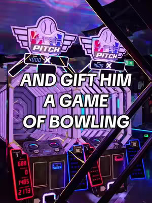 The image showcases an arcade-like setting. The central focus is on dual game machines. Above each machine is a backlit sign with the words "HYPER PITCH" and a logo featuring a baseball. The sides of the machines display illuminated panels in red and blue tones, and the digital displays showing game scores are visible too. The background is dim, suggesting artificial lighting. Overlaid on the image is white text: "AND GIFT HIM A GAME OF BOWLING."