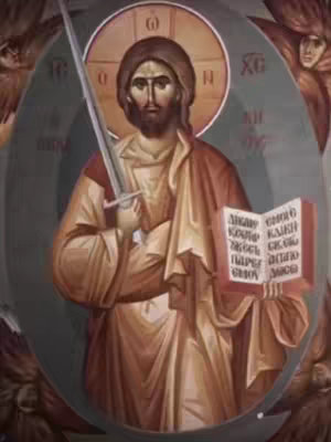 An artistic depiction of a religious figure, possibly a saint or Jesus, holding a sword and an open book with scripture. The figure is depicted with a halo, and the background includes faded circular elements and angelic figures.