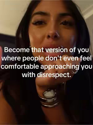 Close-up selfie of a woman with dark hair and makeup, gazing at the camera, with an overlayed text. The background is slightly out of focus.