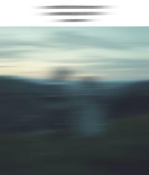 An abstract image with a blurred landscape effect. The top area has horizontal blurred lines. The main part of the image is a blurred view of nature, possibly a landscape with mountains and sky. The colors are muted, with blues, greens and whites.