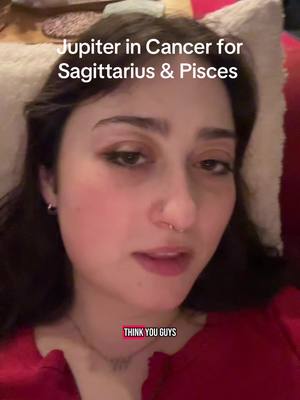 A selfie-style image showing a young woman looking directly at the camera, lying on a bed. The background is blurred, with a red, patterned pillow visible. Overlaid text at the top reads 'Jupiter in Cancer for Sagittarius & Pisces'.