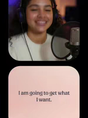 The image is a split-screen. The top half shows a young woman with curly hair smiling and wearing headphones and a microphone in front of her. The bottom half is a pink-beige rectangle with the text overlay that reads: 'I am going to get what I want.'