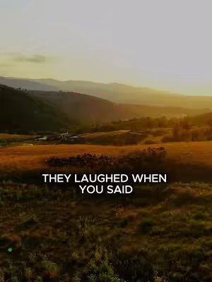 A scenic vista with rolling hills bathed in the warm light of a setting sun. The foreground is filled with grassy fields, and a line of text is overlaid on the image.
