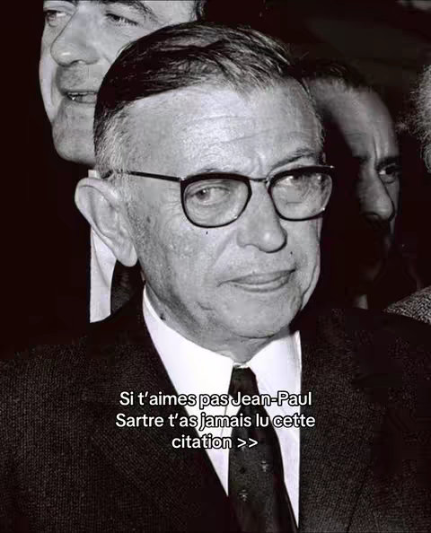 A black and white photo featuring three men in suits. The focal point is a man with glasses and a serious expression. Text is overlaid at the bottom.
