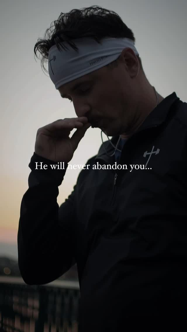 The image features a man looking down, with text overlayed. He's wearing a headband and a black jacket with a cross logo. The background shows a blurred outdoor scene, likely at sunset.