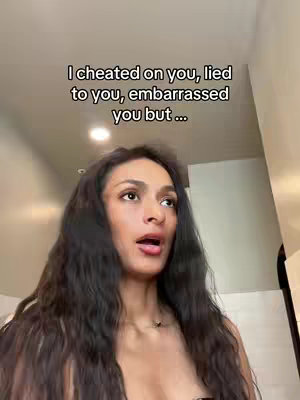 A woman with long, dark hair is looking up and to the side with a slightly open mouth, as if surprised or reacting to something. Text overlay at the top details the beginning of a sentence.
