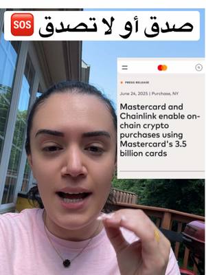 A woman with dark hair is looking at the camera and speaking. Above her head, there is a banner with text in Arabic and a red 'SOS' badge on the left. To her right, a press release about Mastercard and Chainlink is displayed. The background shows a green outdoor setting.