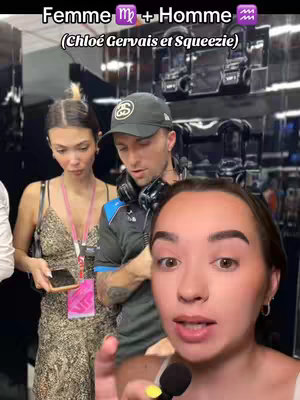A selfie-style image with a woman in the foreground, holding a microphone and pointing her finger while seemingly speaking. She is the dominant visual element, filling much of the frame. Behind her, a woman and a man are present. The man wears a cap and headphones, and the background has a tech/equipment setup, likely a media/event location. Text overlay shows the topic.