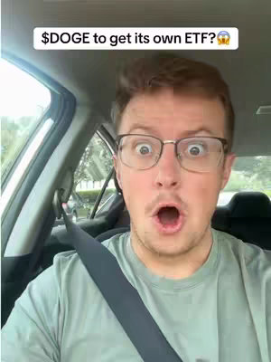 A selfie taken from inside a car. The foreground features a man with glasses, open mouth, and wide eyes, conveying surprise. The background shows the inside of the car and obscured elements outside the car.