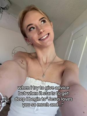 A young woman looks up and smiles, with text overlaid on the image. She's holding the camera at arm's length, a typical selfie angle.