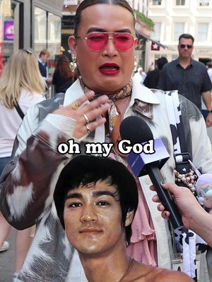 A person wearing a jacket, sunglasses, and jewelry. Below is a picture of Bruce Lee being held by someone.