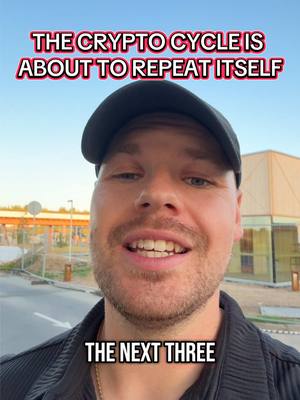 A selfie-style video cover image. The creator is a fair-skinned man wearing a black cap and shirt, smiling with his mouth open. The background is a mix of a clear blue sky and a building with reflections. Text overlays include 'THE CRYPTO CYCLE IS ABOUT TO REPEAT ITSELF' at the top and 'THE NEXT THREE' at the bottom.