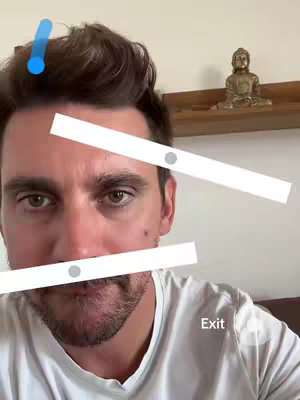 A selfie-style image featuring a man looking towards the camera. Overlayed are animated bars with gray dots. In the background, there's a shelf holding a golden Buddha statue.