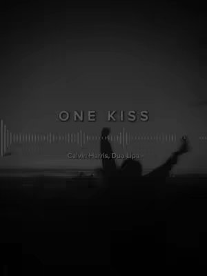 A grayscale image featuring the text 'ONE KISS' overlaid on a silhouette of a person with raised arms, set against a dark sky. Below the text is the artist information, with a visualized audio waveform in the background.