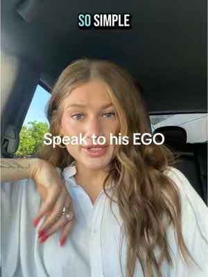 A woman with long brown hair is sitting in a car, looking at the camera and speaking. There is text overlay on the image.
