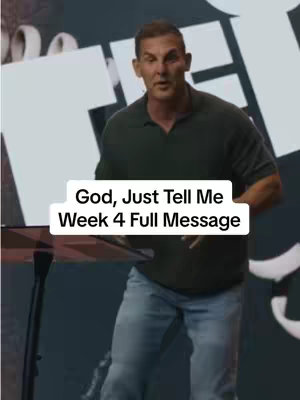 A man standing behind a podium delivering a message. A white rectangular text box overlays the image, displaying the text 'God, Just Tell Me Week 4 Full Message'. The background is a dark, blurred setting.