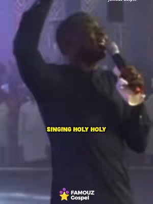 A man singing into a microphone with his arm raised. The background is blurred, but appears to be a stage setting with lights. Overlay text emphasizes the song's message.