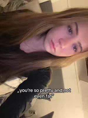 A young woman is shown from a close angle, with her face and long hair taking up most of the frame. She appears to be lying down, with a soft background of what seems to be a bed or couch. The text overlay is in white.