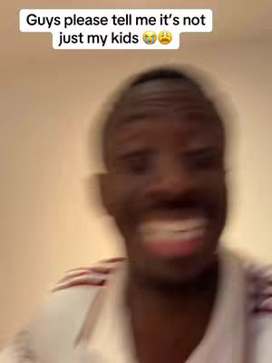 The cover image shows a blurry, close-up shot of a man with dark skin, likely of African descent, with a slightly blurred background. The man likely has short, dark hair, with a white collared shirt with red stripes on the shoulders, and the man is mid-laugh. The hook text is positioned at the top of the frame.
