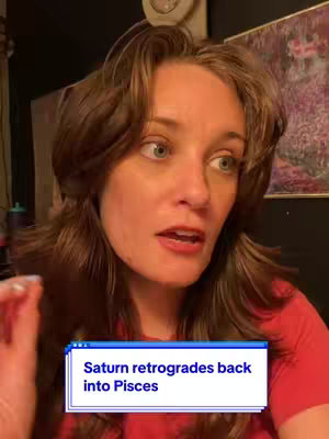 A woman with brown hair and a red shirt is looking to her right, seemingly speaking. A text box with the words "Saturn retrogrades back into Pisces" is in the bottom center. The background suggests a personal space, with a wall and artwork.
