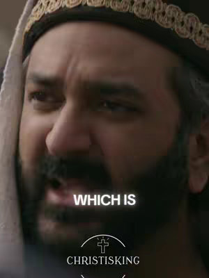 The image is a close-up of a man's face, likely taken from a video. The man has a dark beard, mustache, and dark eyes. He appears to be wearing a dark hat with an ornate, gold-colored trim. A white cloth is draped over his head. Overlayed on the image is white text that reads "WHICH IS," above a graphic that combines a cross with a crown and the word "CHRISTISKING" below.