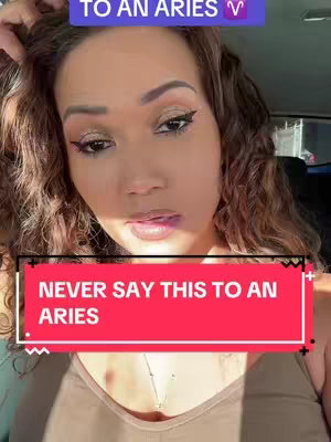 A woman with curly brown hair and makeup looks directly at the camera. Text overlays on a red background with white text, saying, "NEVER SAY THIS TO AN ARIES,". Above this is a purple box with white font, and the Aries zodiac sign.