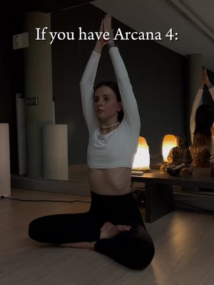 A woman in a yoga pose with her arms raised, wearing a white top and black pants with the text "If you have Arcana 4:" overlaid.