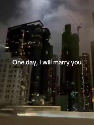 The cover image shows a cityscape at night, with numerous lit buildings and a dark, cloudy sky. Text overlayed on the image reads 'One day, I will marry you.' The buildings are tall, suggesting a dense urban environment, and the overall composition is moody and romantic.