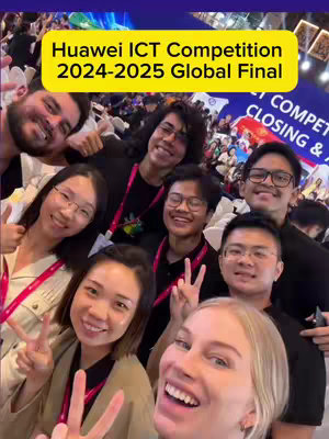 A selfie of a group of young adults smiling and posing for the camera at the Huawei ICT Competition. They are making various hand gestures, and a yellow banner with white text that reads 'Huawei ICT Competition 2024-2025 Global Final' is at the top.
