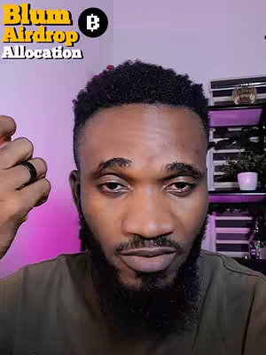 A close-up shot of a man with a beard and short, black hair. The man is looking at the camera. The background is blurred, with a pink and purple gradient color in the background. There is text overlaid on the image.