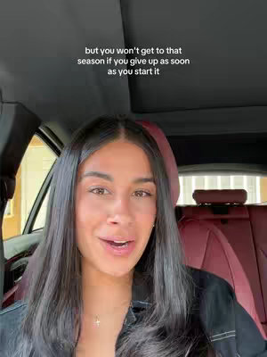 The cover image shows a woman sitting in the driver's seat of a car, looking slightly upwards and to the right with a soft expression. The interior of the car is visible—a dark dashboard, burgundy leather seats, with the open window showing a bright, outdoor scene. Text is overlaid at the top, providing context for the video.