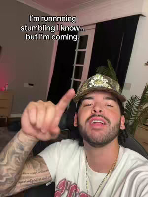 The cover image shows a man with a beard and a camouflage cap pointing at the camera with one finger. The text overlay is at the top of the image.