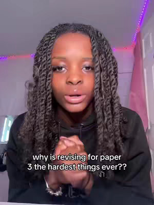 A young woman with long, braided hair is centered in the frame, looking directly at the camera with a slightly concerned expression. The background is softly lit with pink and purple hues, and text overlays are present at the bottom, indicating the video's focus on study-related topics.
