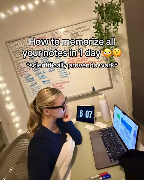 A young woman is sitting at a desk with a laptop, an iPad, and notes visible. There is text overlayed on the whiteboard describing methods for memorizing notes.