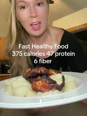 A woman holding a plate with food, likely to be chicken and mashed potatoes with a text overlay displaying nutritional facts.