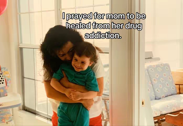 A woman embraces a young child indoors, with the child smiling and the woman's face partially obscured. Text overlays the image.