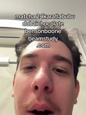 A selfie-style video cover featuring a young man with dark hair and a mustache, looking directly at the camera. Text overlays at the top include multiple words and a website address. The background is plain.