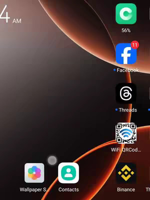 The image is a screenshot of a mobile phone's home screen. The background features a gradient of dark colors with some orange and red accents. Several app icons like Facebook, Threads, and Binance are visible. The time 4 AM is shown at the top left, with a battery indicator at 56%.